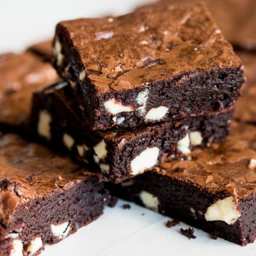 several brownies stacked on top of each other with white and chocolate chips in them