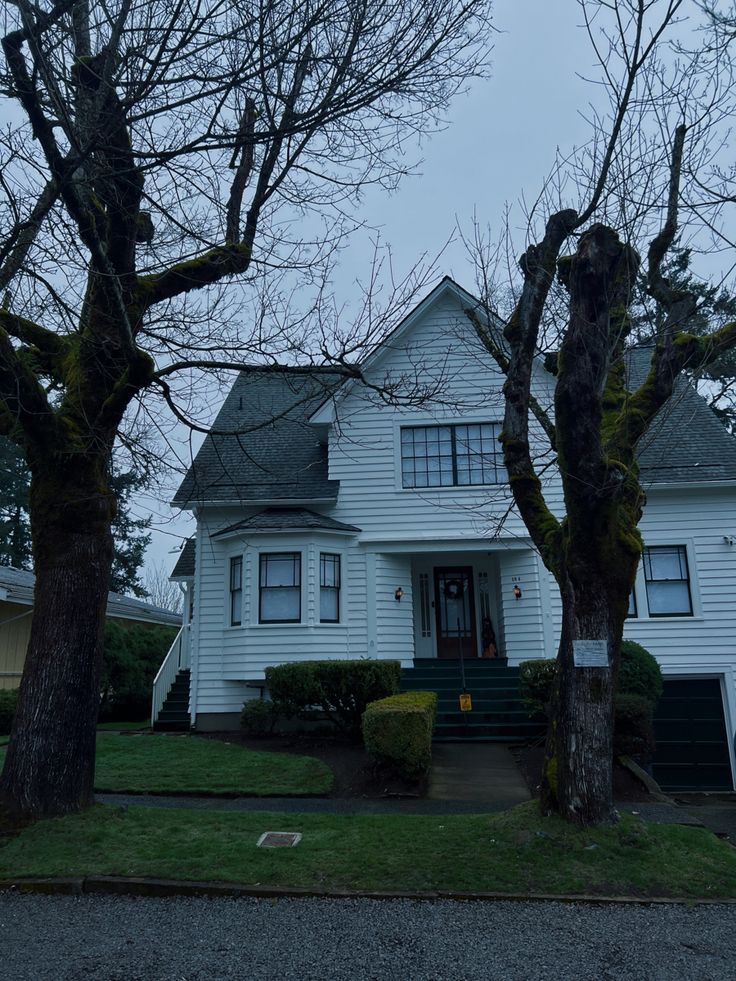 a white house with trees in front of it