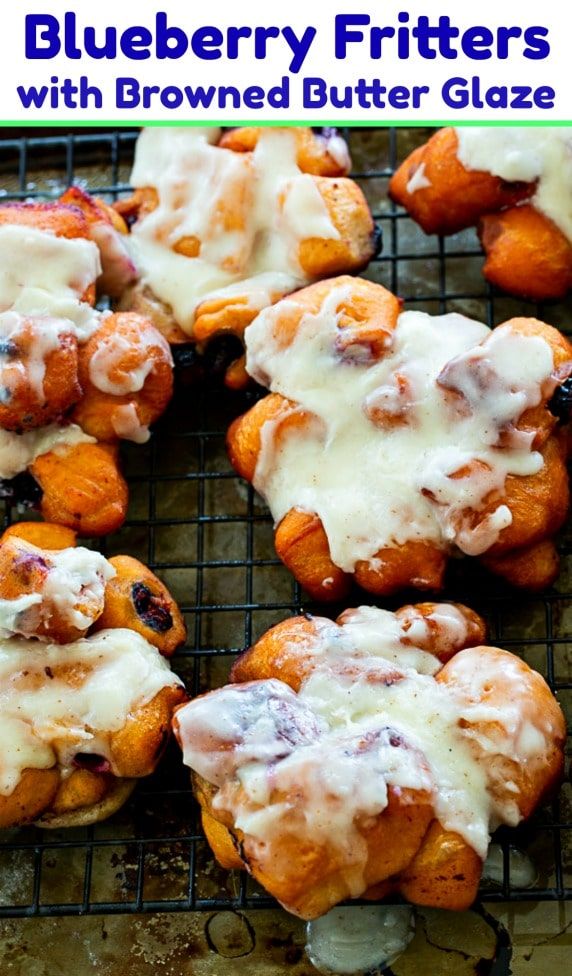 blueberry fritters with browned butter glaze are on a cooling rack