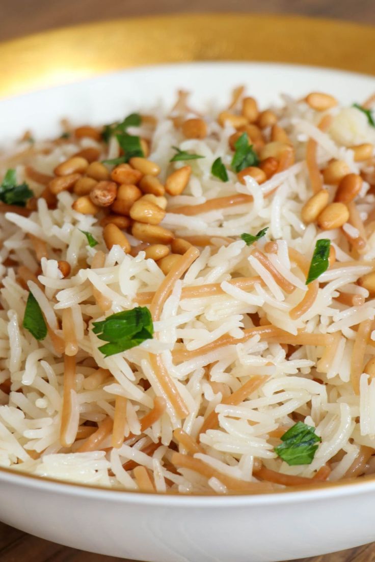 a white bowl filled with rice and nuts