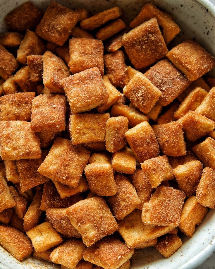 a white bowl filled with sugar cubes on top of a table