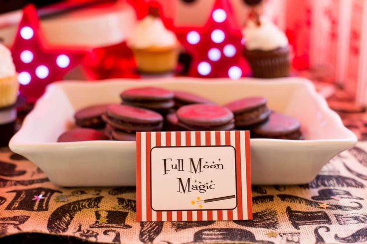 cupcakes and pastries are on display in a white dish at a circus themed birthday party