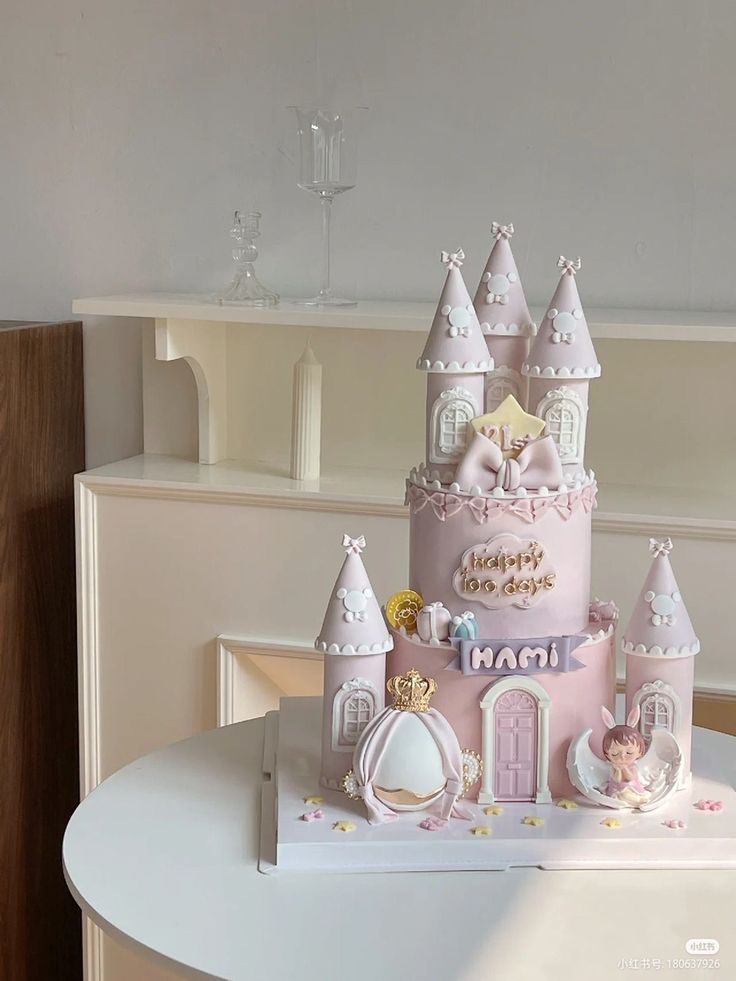 a pink princess castle cake sitting on top of a table