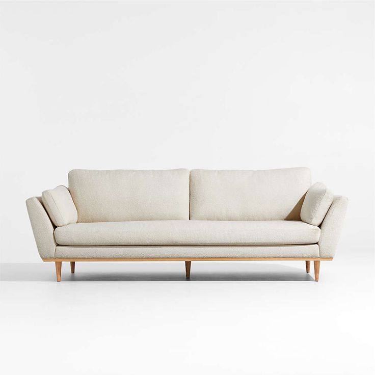 a white couch sitting on top of a wooden frame