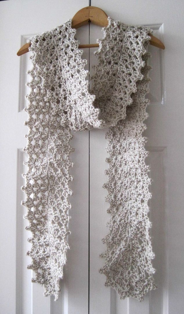 a crocheted scarf hanging on a door