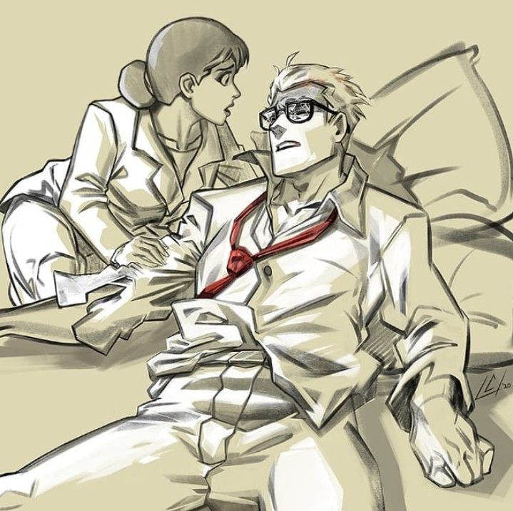 two people sitting next to each other on a bed with one person wearing glasses and the other in a red tie