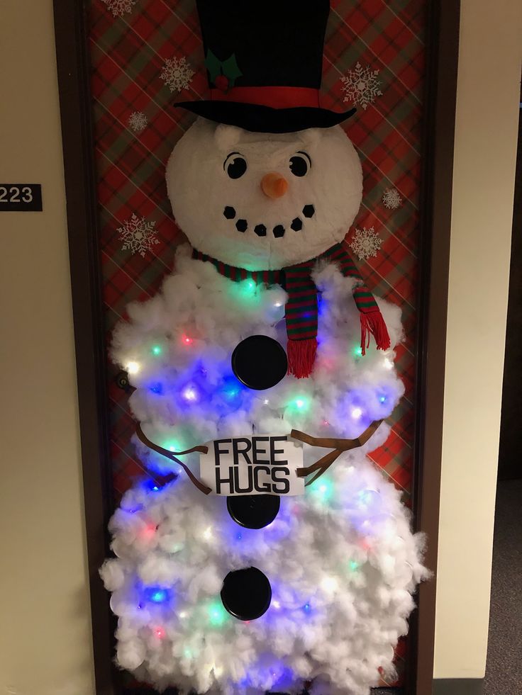 a lighted snowman in a box with the words free hugs on it