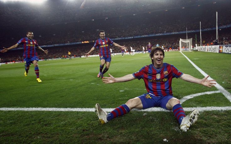 a soccer player sitting on the ground with his arms wide open and hands out in celebration