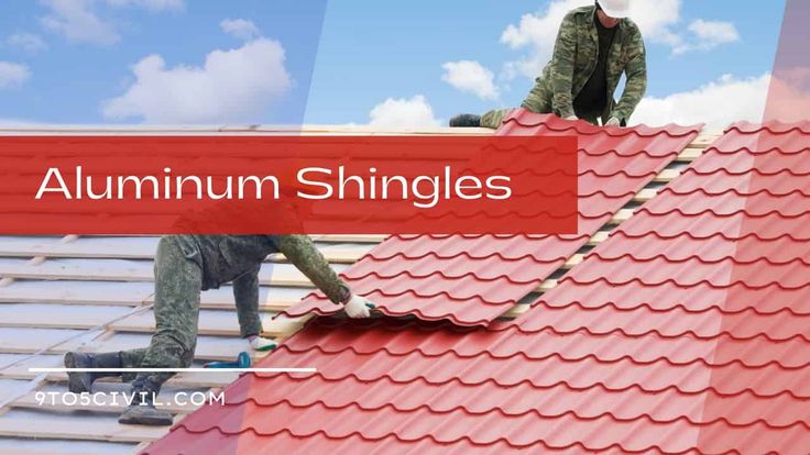 two men working on the roof of a building with red shingles and white clouds in the background