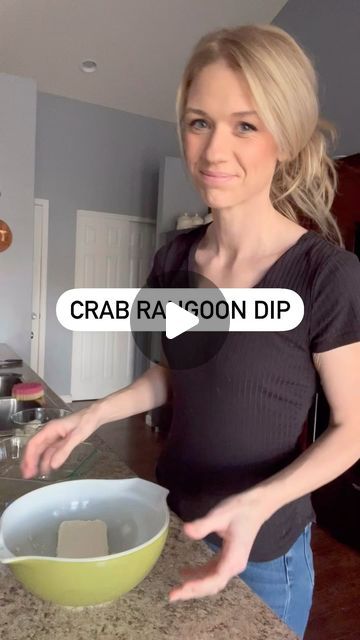 a woman standing in front of a counter with a bowl on it