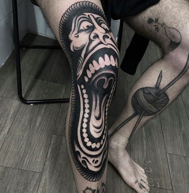 a man's legs with tattoos on them and his leg is covered in black ink