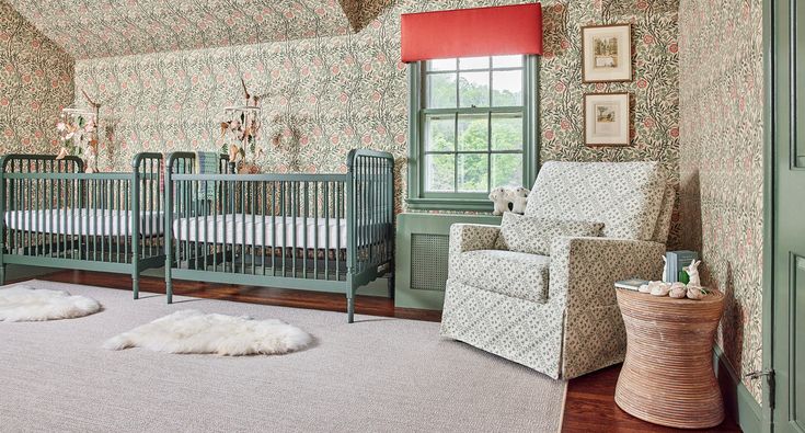 a baby's room with two cribs and a chair in the corner