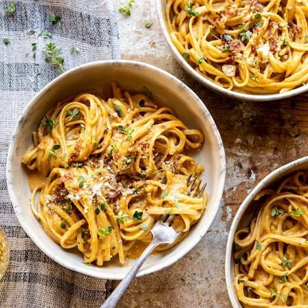 three bowls filled with pasta on top of a table