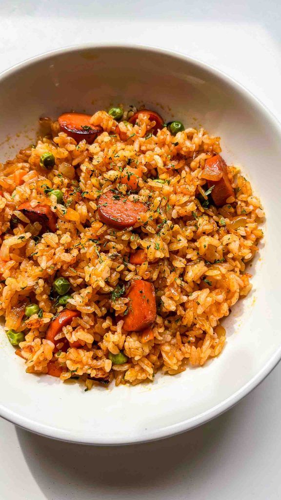 a white bowl filled with rice and vegetables