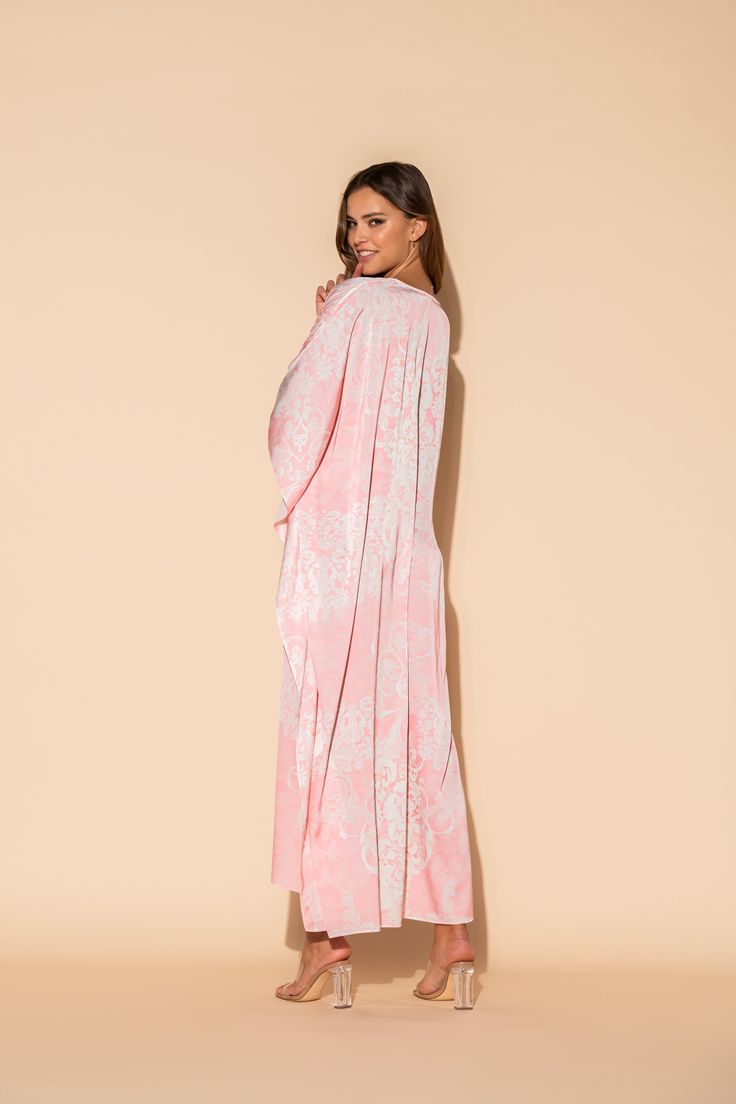 This damask print is a lovely combination of pale pink and white in our Romantique long caftan. The long, flowing caftan is made out of our signature Polysilk fabric for that all-day luxe vibe. Cover-up? Sure. Loungewear? Why not? Brunch with friends? Definitely. Sleepwear? Absolutely. Machine washable for ease of care. Elegant Pink V-neck Kimono, Pink Silk Maxi-length Kaftan, Pink Silk Maxi Kaftan, Pink Silk Maxi Length Kaftan, Elegant Long Pink Thobe, Elegant Long Pink Kaftan, Elegant Pink Kimono For Loungewear, Pink Elegant Kimono For Loungewear, Elegant Maxi Length Kimono For Daywear