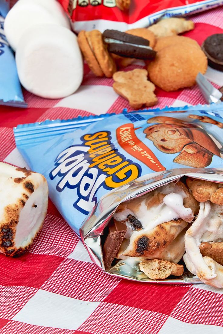 a bag of food sitting on top of a red and white checkered table cloth