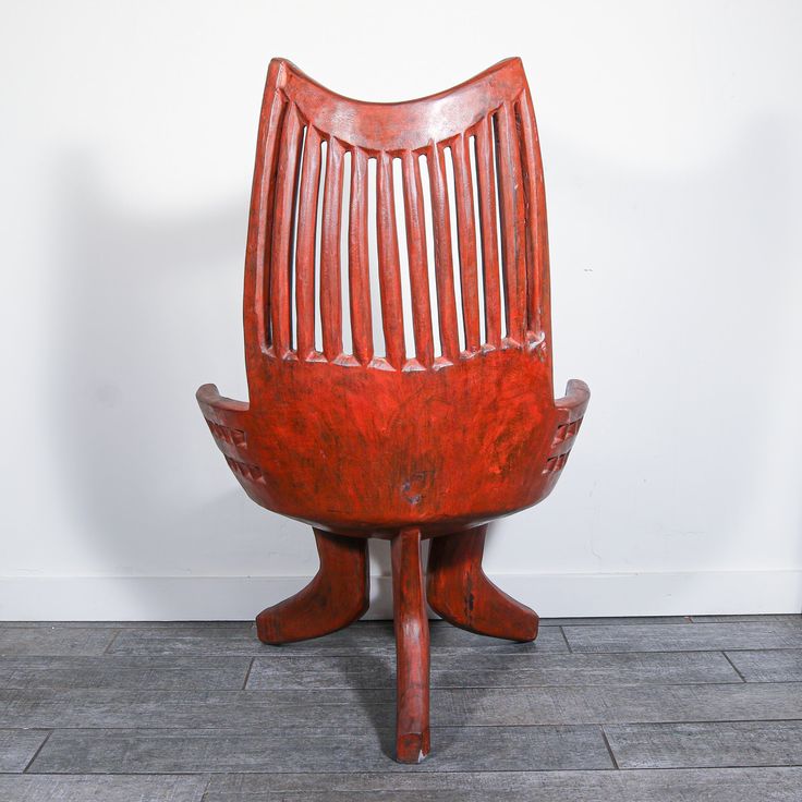 a wooden chair sitting on top of a tile floor