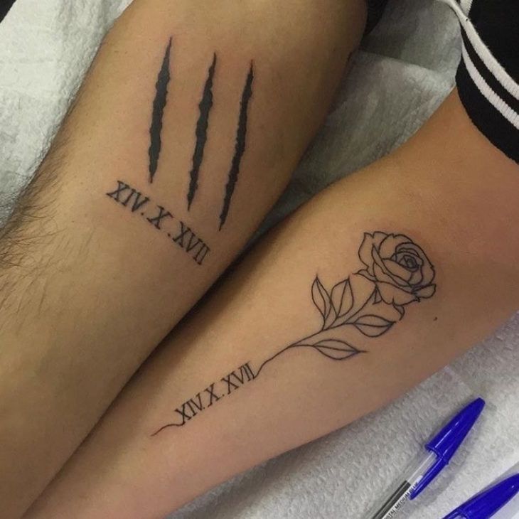 two people with matching tattoos on their legs, one has a rose and the other has an arrow