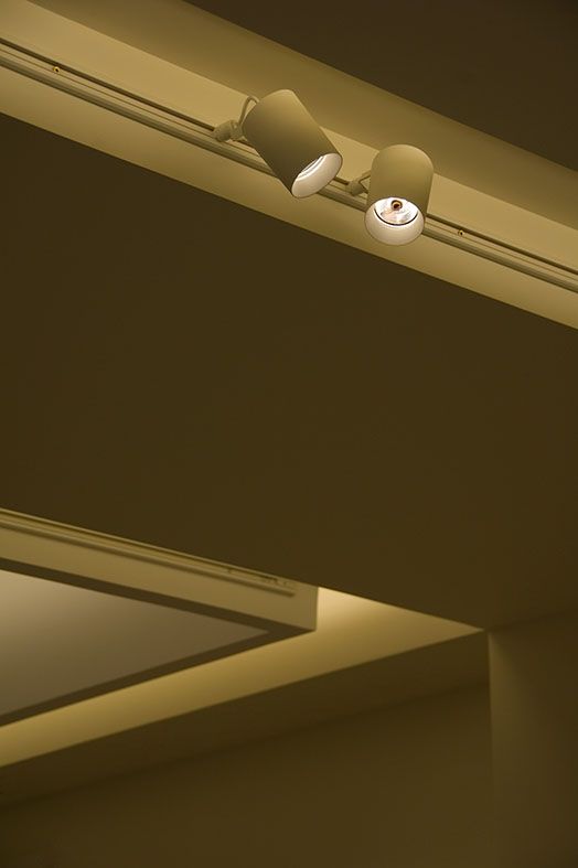 two lamps are on the ceiling in an empty room