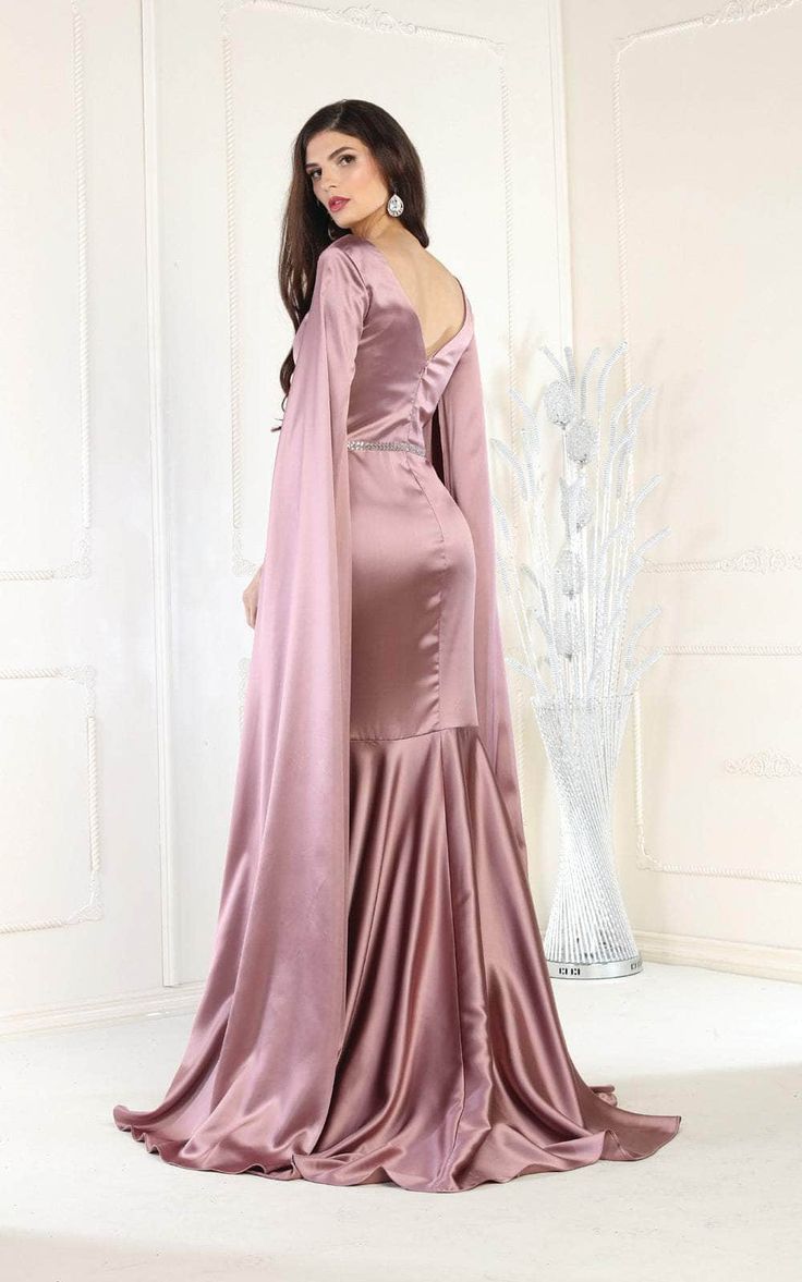 Glamour up for your special day in this May Queen RQ7961 evening dress. This dress features floor length cape sleeves and a V neckline with an illusion inset. The skirt has a floor length sheath silhouette and is finished off with a sweep train. Has a jewel embellished waistband and is finished off with a V back. Fall in love with the beauty of this May Queen RQ7961 creation. Dress is pictured in Black, Hunter Green, and Mauve colors. Style: mayq_RQ7961 Details: Floor Length Cape Sleeves, Illusi Cape Evening Dress With Sweep Train, Cape Evening Dress With Sweep Train For Party, Prom Gown With Sweep Train And Cape Sleeves, Party Gown With Sweep Train And Cape, Party Gown With Sweep Train And Cape Design, Party Evening Dress With Sweep Train And Cape, Elegant Evening Dress With Cape Sleeves For Prom, Elegant Prom Evening Dress With Cape Sleeves, Evening Gown With Sweep Train And Cape