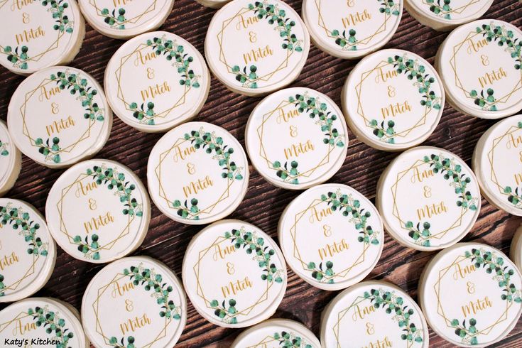 wedding favors with green leaves on them and the names of each guest's guests