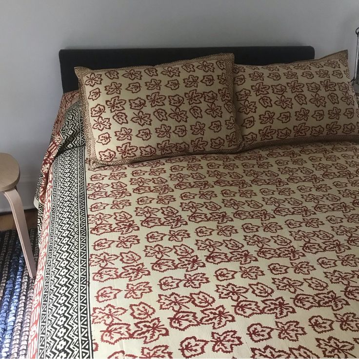 a bed with red and white bedspread on top of it