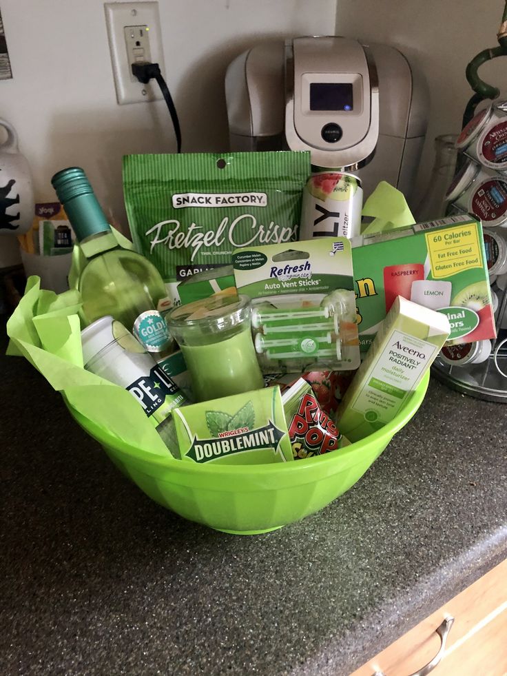 a green bowl filled with various items on top of a counter