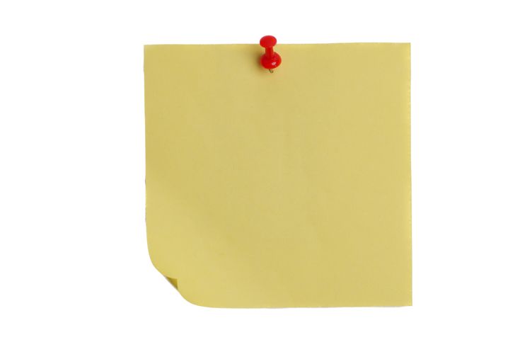 a piece of yellow paper with a red push pin on it, against a white background