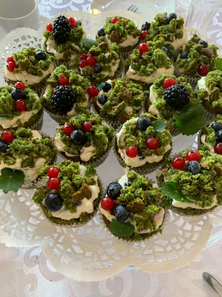 a white plate topped with cupcakes covered in toppings