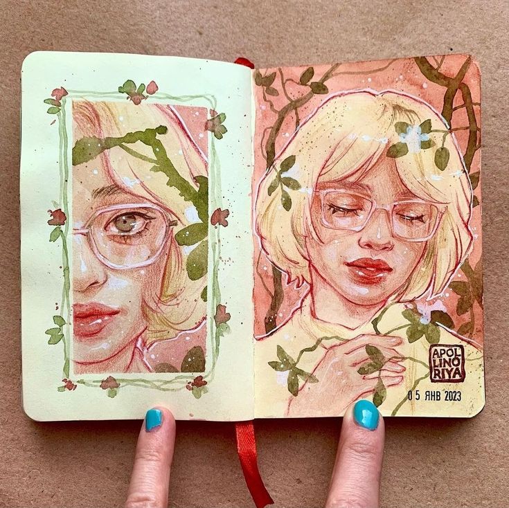 a hand is holding an open book with two images of women in glasses on it