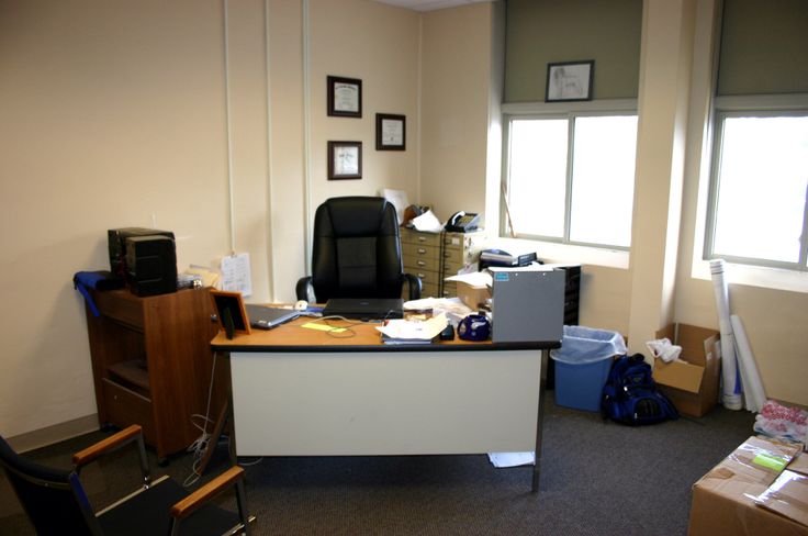 an office cubicle is cluttered with boxes and other items