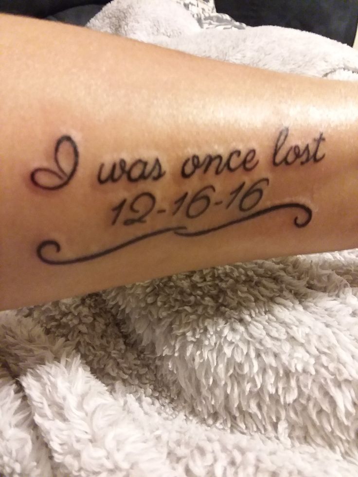 a tattoo saying i was once lost on someone's arm with the date in cursive writing