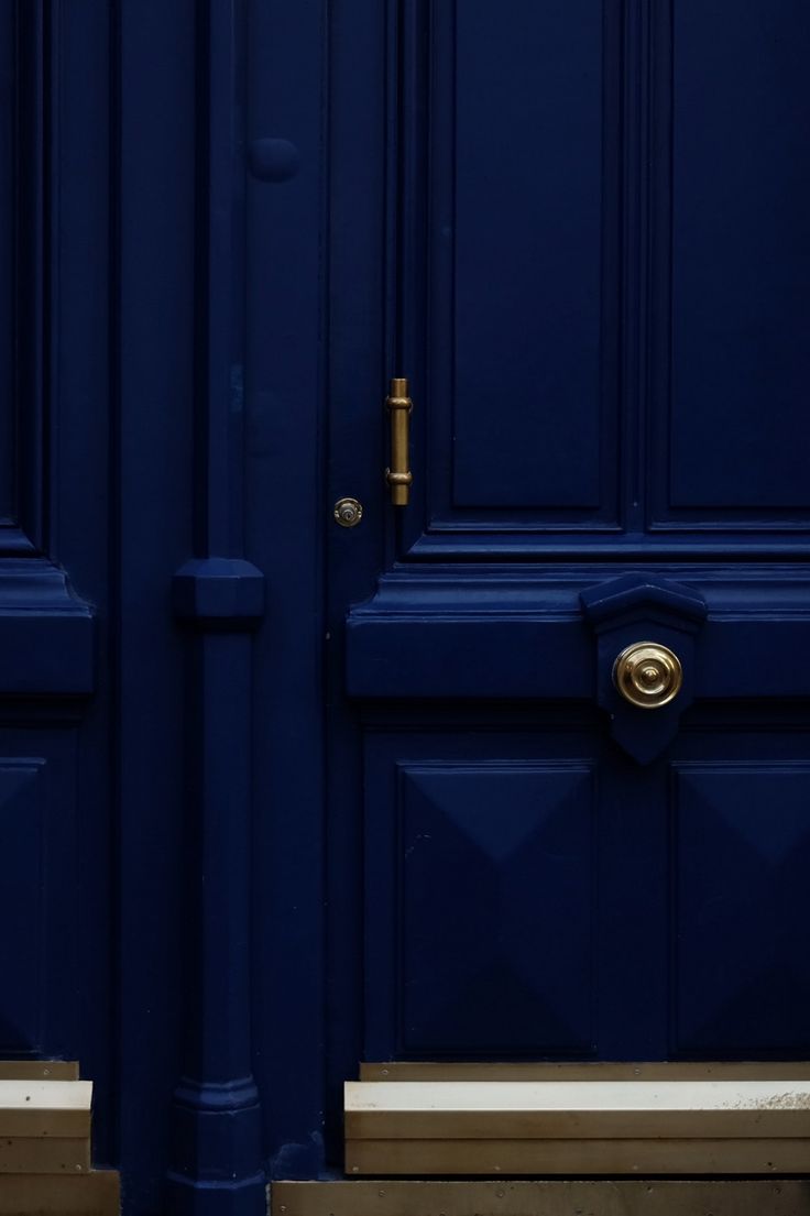 two blue doors with gold handles on them