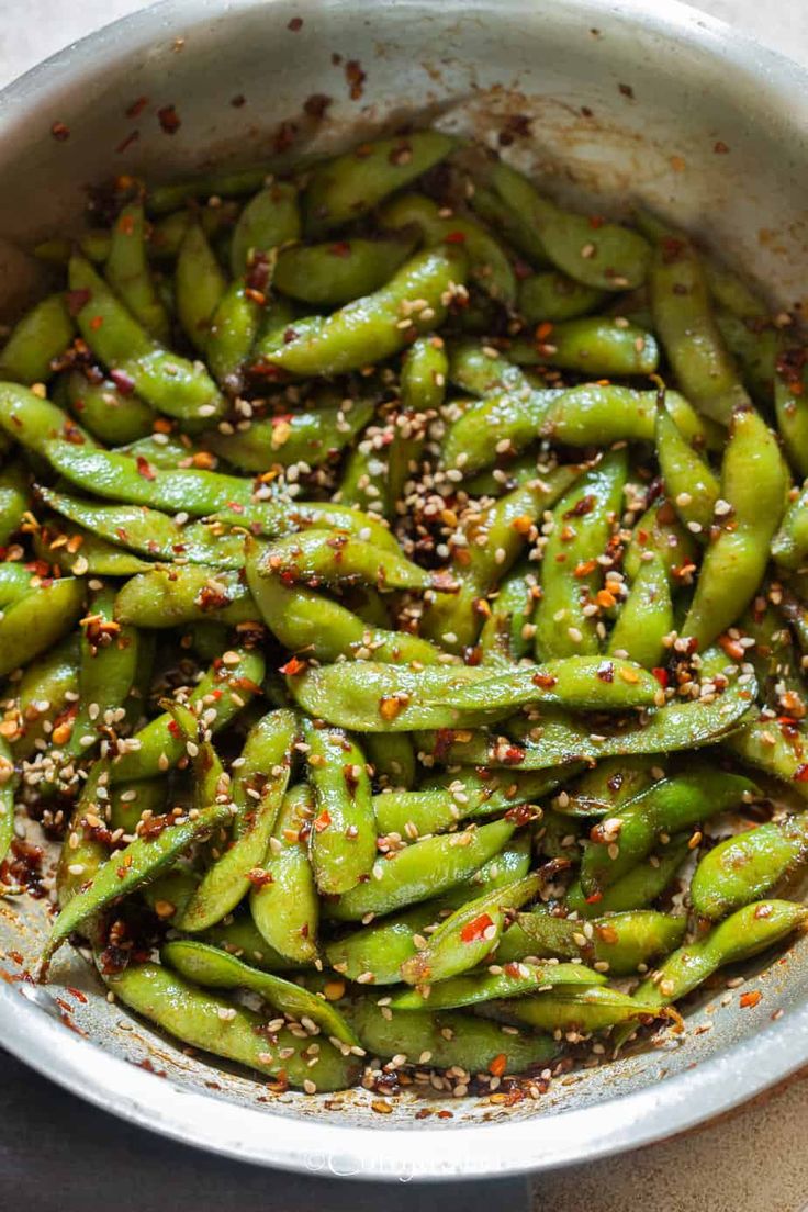 green beans with sesame seeds and seasoning in a bowl