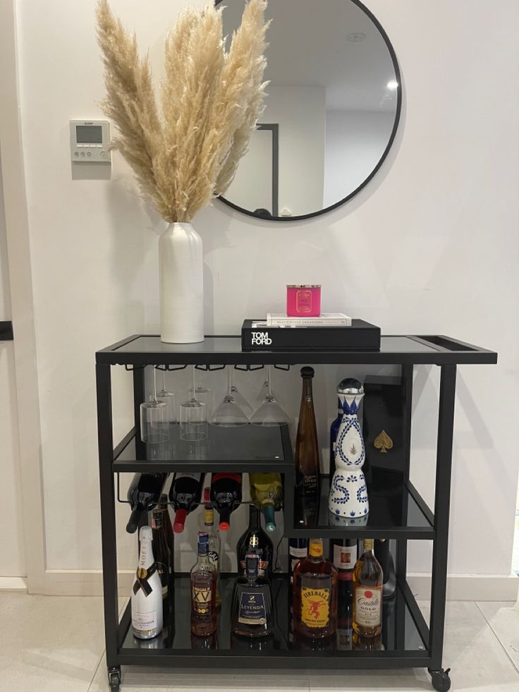 a bar cart with bottles and liquor on it