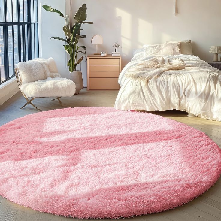 a bedroom with a large pink rug on the floor