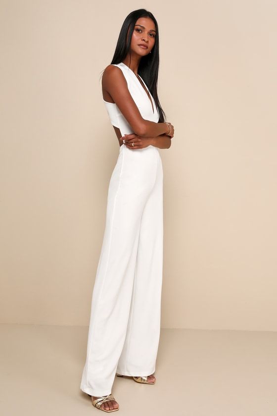 Your admirers will have a lot to say about their love for you in the Lulus Thinking Out Loud White Backless Jumpsuit! Medium-weight crepe knit forms a sleeveless darted bodice with a V-neck and wide straps that cross over the open back. Bit of elastic at the waist tops the wide-leg pants. Fit: This garment fits true to size. Length: Floor length. Size medium measures 62" from shoulder to hem. Inseam: 32.25 Front Rise: 13.00 Bust: Great for any cup size. Waist: Fitted - stretchy fabric allows cus White Backless Jumpsuits And Rompers For Date Night, Fitted Jumpsuit With Back Opening For Date Night, Elegant Sleeveless Jumpsuit With Back Opening, Elegant Fitted Halter Neck Strapless Jumpsuit, Fitted Strapless Sleeveless Jumpsuit For Date Night, Fitted Jumpsuits With Back Opening, Formal Sleeveless Jumpsuit With Back Opening, Formal Sleeveless Jumpsuits And Rompers With Back Opening, Fitted Jumpsuits And Rompers With Back Opening