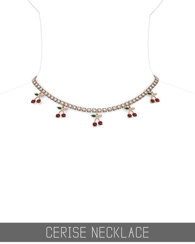 a necklace with red and green stones hanging from it's side, on top of a white background