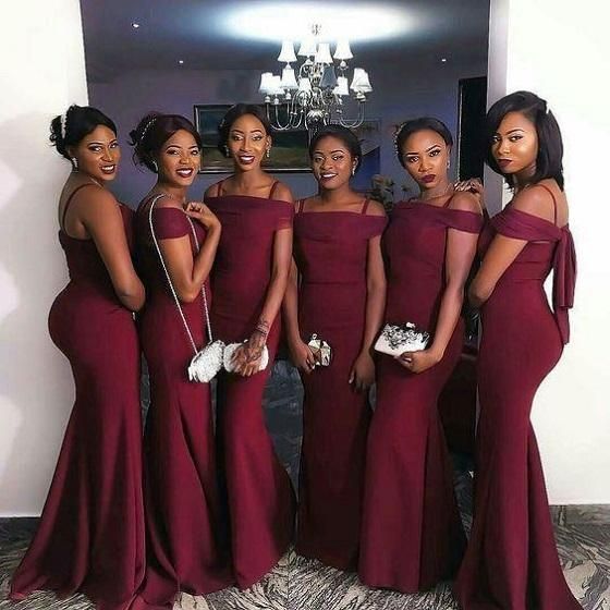 the bridesmaids are posing for a photo in their red gowns and one is holding