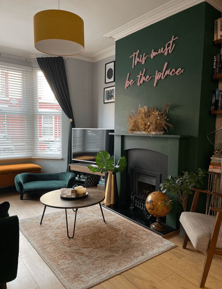 a living room filled with furniture and a fire place in front of a tv mounted on a wall