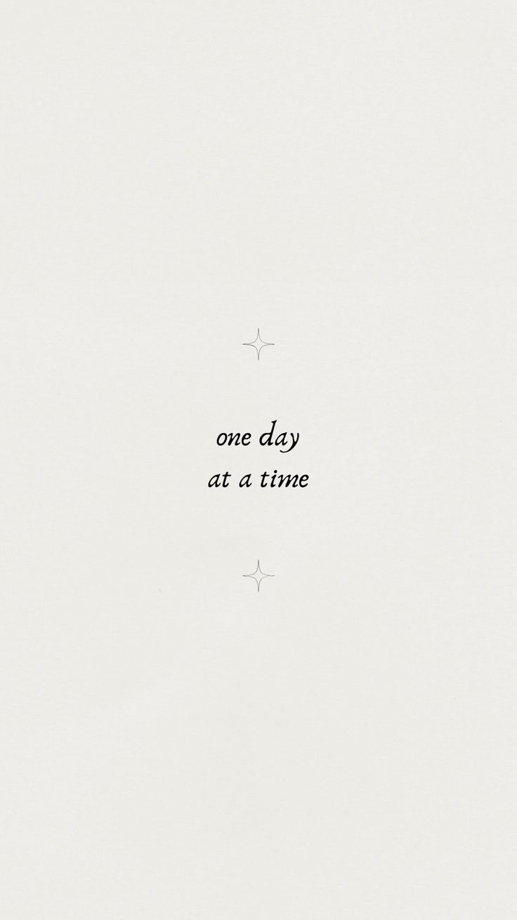 one day at a time written in black ink on white paper