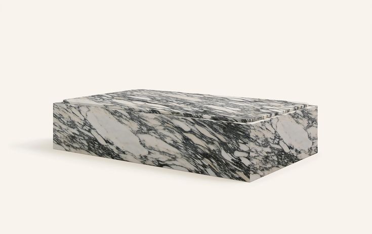 a white and black marble box sitting on top of a table