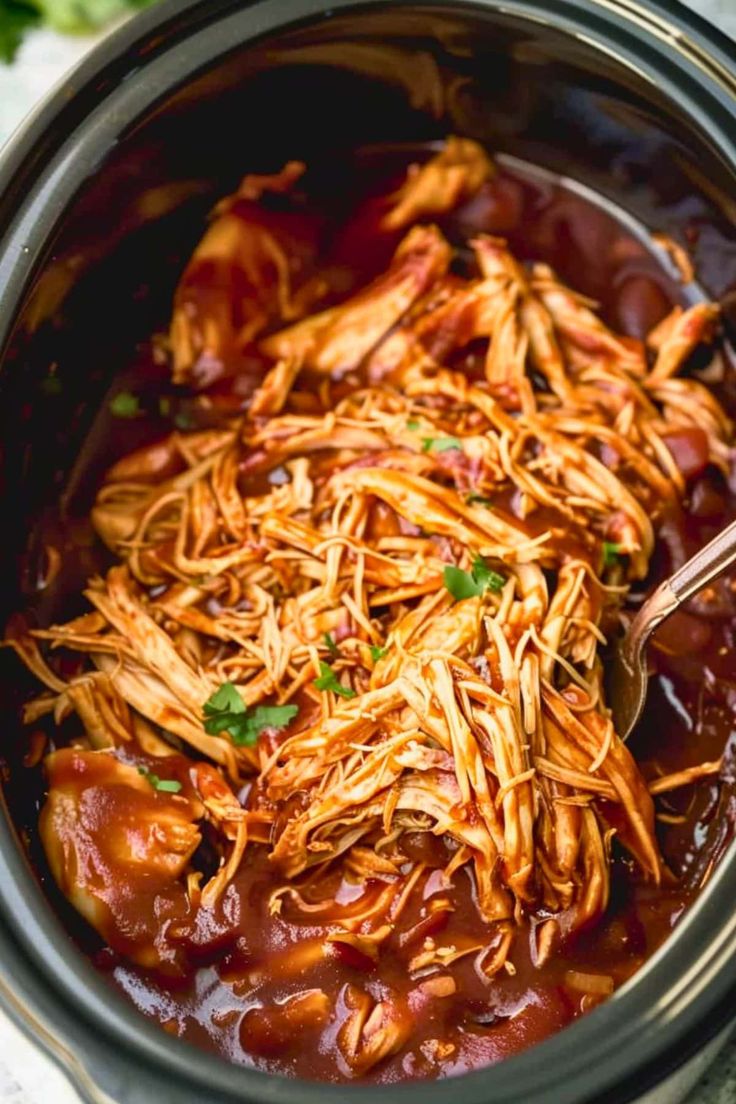 shredded chicken and chili in a slow cooker