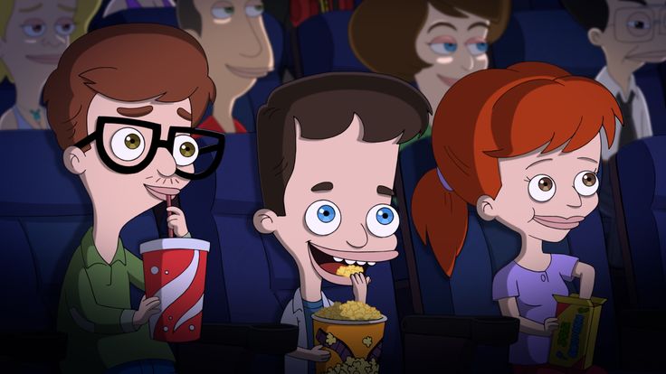 three people sitting in an auditorium with popcorn and soda