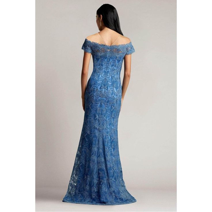 a woman in a blue dress looking back