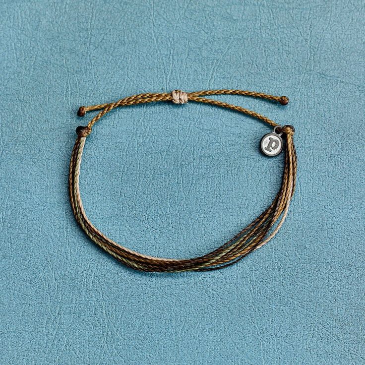 It’s the bracelet that started it all. Each one is handmade, waterproof and totally unique— in fact, the more you wear it, the cooler it looks. Grab yours today to feel the Pura Vida vibes. WaterproofGo surf, snowboard, or even take a shower with them on. Easily AdjustableOne size fits all, easy to slip on and off. 100% waterproof- Wax-coated- Adjustable from approximately 2-5 inches in diameter- Because jewelry products are handcrafted by artisans, dimensions may vary from piece to piece Casual Braided Bracelets With Adjustable Length, Outdoor Adjustable Braided Bracelets With Sliding Knot, Adjustable Braided Bracelets With Sliding Knot For Outdoor, Adjustable Braided Bracelet With Sliding Knot For Outdoor, Casual Everyday Friendship Bracelets Waxed Cord, Casual Everyday Friendship Bracelets With Waxed Cord, Casual Everyday Bracelet, Handmade Adjustable Bracelets For Everyday, Casual Bracelets With Adjustable Cord For Everyday