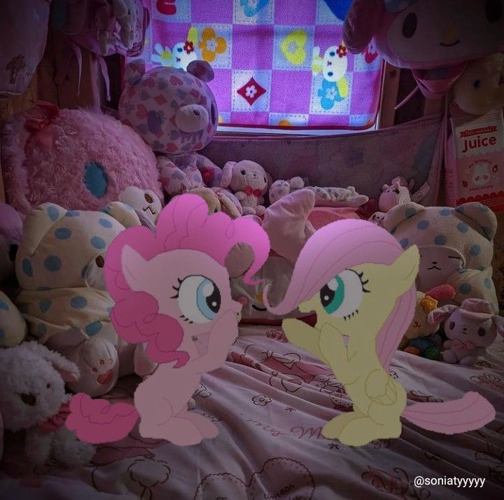 two pinkie ponies sitting on top of a bed surrounded by stuffed animals