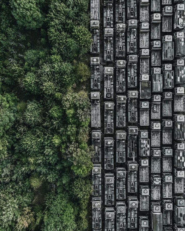 an aerial view of cars parked in the woods