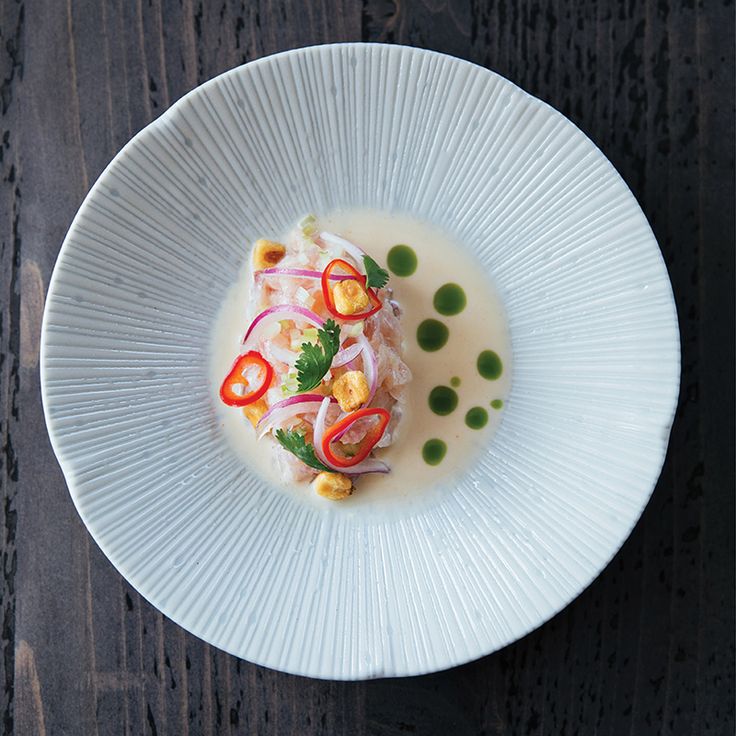 a white plate topped with food on top of a wooden table