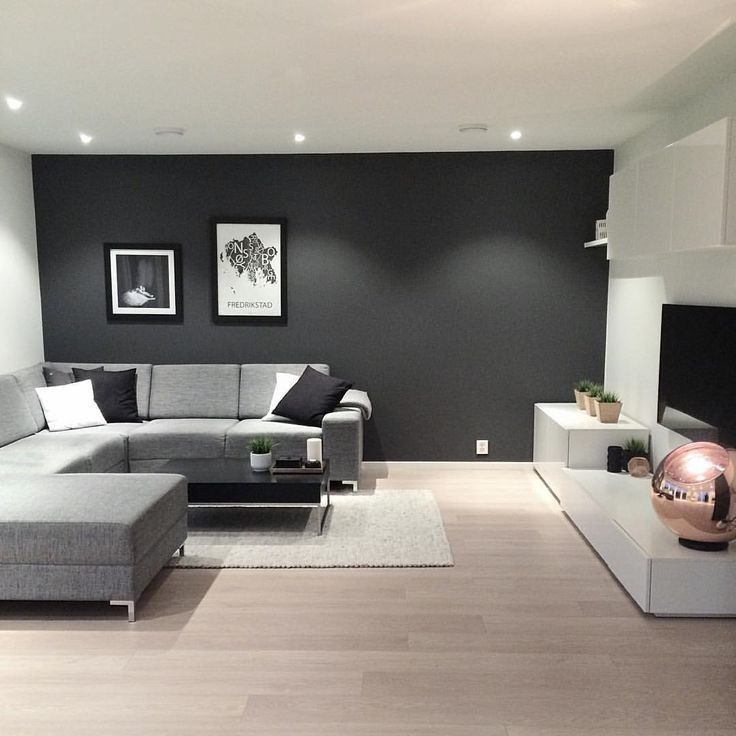 a living room filled with furniture and a fire place next to a wall mounted tv